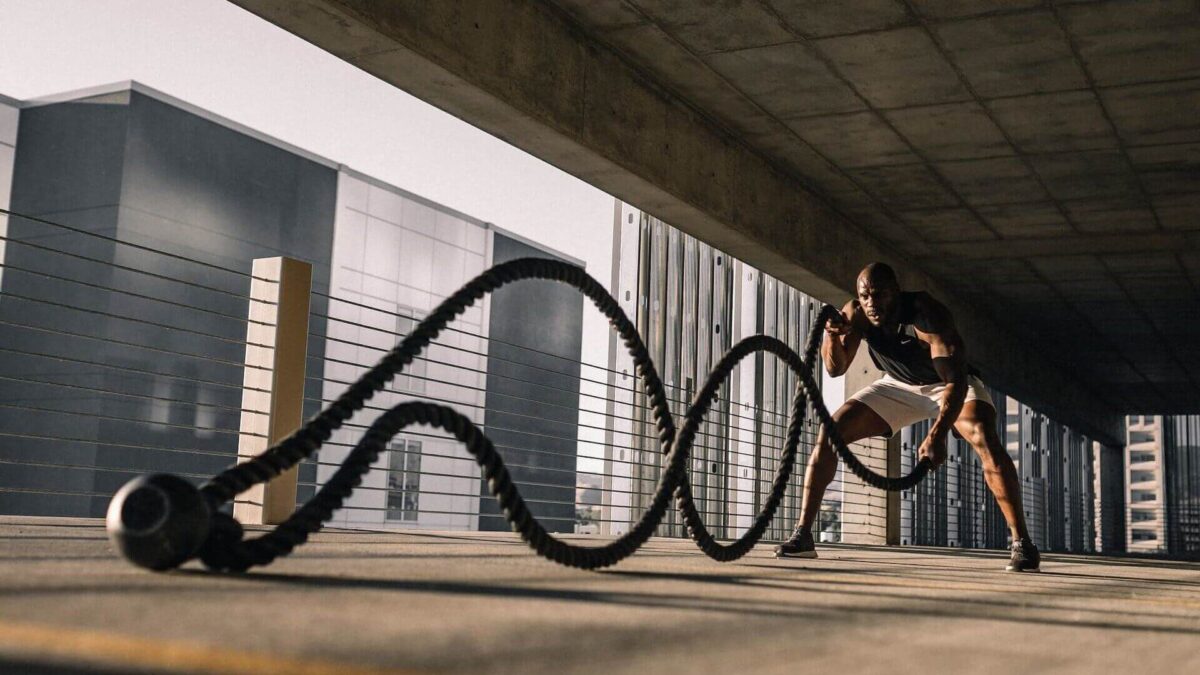 man performing battle ropes